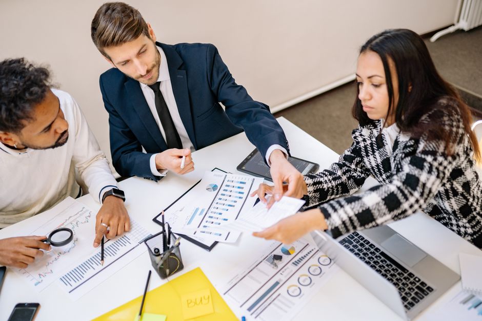Business owner planning website structure on a tablet with notes